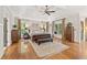 Spacious primary bedroom with hardwood floors, tray ceiling, and large windows for ample natural light at 3750 Maryhill Nw Ln, Kennesaw, GA 30152
