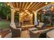 Cozy outdoor living area features a stone fireplace and comfortable seating, perfect for evening relaxation at 3750 Maryhill Nw Ln, Kennesaw, GA 30152