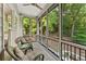 Relax on this screened porch featuring wooded views and comfortable seating at 3750 Maryhill Nw Ln, Kennesaw, GA 30152