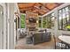 Inviting sunroom with stone fireplace, wood ceiling, and windows showcasing the lush outdoor scenery at 3750 Maryhill Nw Ln, Kennesaw, GA 30152
