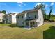 Backyard featuring a well-maintained lawn, a gray home exterior, and an outdoor seating area at 776 Clifftop Xing Xing, Powder Springs, GA 30127