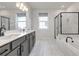 Contemporary bathroom features dual sinks, a soaking tub, and a glass-enclosed shower at 776 Clifftop Xing Xing, Powder Springs, GA 30127