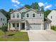 Charming two-story home featuring a stone and gray shingle exterior, complemented by a well-manicured lawn at 776 Clifftop Xing Xing, Powder Springs, GA 30127