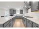 Spacious kitchen featuring gray cabinets, quartz countertops, and modern appliances at 776 Clifftop Xing Xing, Powder Springs, GA 30127