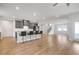 Open-concept kitchen with gray cabinets, a breakfast bar, and hardwood floors at 776 Clifftop Xing Xing, Powder Springs, GA 30127