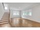 Bright living room features hardwood floors and multiple windows that provide ample natural light at 776 Clifftop Xing Xing, Powder Springs, GA 30127