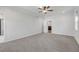 Large main bedroom with plush carpet and a view to the ensuite bathroom and bonus seating area at 776 Clifftop Xing Xing, Powder Springs, GA 30127