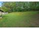 Lush backyard with a patio area and mature trees providing ample shade and privacy at 107 Hearthstone Walk, Woodstock, GA 30189