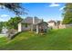 Spacious backyard featuring a well-maintained lawn, a patio area, a covered porch, and mature trees at 107 Hearthstone Walk, Woodstock, GA 30189