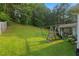 Well-maintained backyard with mature trees, play equipment, and a covered gazebo offering a relaxing outdoor space at 107 Hearthstone Walk, Woodstock, GA 30189