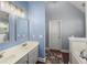 Bathroom featuring dual sinks, vanity lights, and neutral paint at 107 Hearthstone Walk, Woodstock, GA 30189