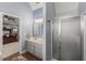 Bathroom with dual vanity sinks and shower stall; has a view to the main bedroom at 107 Hearthstone Walk, Woodstock, GA 30189