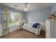 Bright bedroom with blue walls, white trim, and a window with floral curtains at 107 Hearthstone Walk, Woodstock, GA 30189
