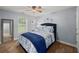 Bedroom with blue walls, carpet, and a bed with blue and white floral bedding at 107 Hearthstone Walk, Woodstock, GA 30189