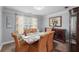 Formal dining room featuring crown molding, warm lighting, and room for six at 107 Hearthstone Walk, Woodstock, GA 30189
