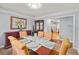 Dining room with a view to the kitchen, featuring crown molding and room for six at 107 Hearthstone Walk, Woodstock, GA 30189