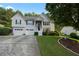 Charming two-story home with a two-car garage and landscaped front yard at 107 Hearthstone Walk, Woodstock, GA 30189