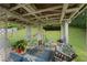 Inviting covered patio with comfortable seating and a view of the expansive backyard at 107 Hearthstone Walk, Woodstock, GA 30189
