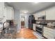 Well-lit kitchen featuring granite countertops, stainless steel appliances, and hardwood floors at 107 Hearthstone Walk, Woodstock, GA 30189