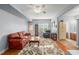 Open living room featuring a comfortable seating area and hardwood floors at 107 Hearthstone Walk, Woodstock, GA 30189