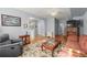 Inviting living room with wood floors, area rug, and comfortable seating at 107 Hearthstone Walk, Woodstock, GA 30189