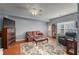 Cozy living room with a floral patterned rug, couch, and arm chair at 107 Hearthstone Walk, Woodstock, GA 30189