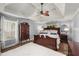 Spacious main bedroom with a tray ceiling, ceiling fan, and a large bed at 107 Hearthstone Walk, Woodstock, GA 30189