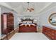 Cozy main bedroom with a tray ceiling, ceiling fan, and a large bed at 107 Hearthstone Walk, Woodstock, GA 30189