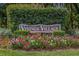 Vinings Village sign surrounded by colorful flowers and greenery at 3074 Vinings Ridge Se Dr, Atlanta, GA 30339