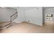 Open-concept living space with hardwood floors, a staircase, and access to an outdoor patio at 3074 Vinings Ridge Se Dr, Atlanta, GA 30339