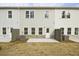 The back of the home with a yard, patio, and rear entrance at 174 Bluffington Way, Marietta, GA 30066