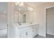 Bathroom vanity with dual sinks, white cabinets and large mirror with modern lighting at 174 Bluffington Way, Marietta, GA 30066
