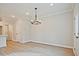 Bright dining room with hardwood floors, modern chandelier, and crisp white trim at 174 Bluffington Way, Marietta, GA 30066