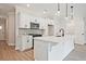 Well-appointed kitchen showcasing white cabinetry, stainless steel appliances, and a functional island with a sink, ideal for cooking at 174 Bluffington Way, Marietta, GA 30066