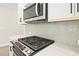 Stainless steel gas range and microwave with gray subway tile backsplash at 174 Bluffington Way, Marietta, GA 30066