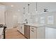 Contemporary kitchen featuring a large island, stainless steel dishwasher, and pendant lighting, adding a touch of elegance at 174 Bluffington Way, Marietta, GA 30066