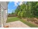 Backyard with grass, patio, trees, and a privacy fence at 1955 Pius Dr, Ellenwood, GA 30294