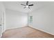 Bright bedroom with carpeted floor, ceiling fan and natural light from large window at 1955 Pius Dr, Ellenwood, GA 30294