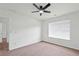 Bedroom with neutral carpet, ceiling fan and large window at 1955 Pius Dr, Ellenwood, GA 30294