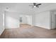 Spacious bedroom with large windows, ceiling fan, and neutral carpet at 1955 Pius Dr, Ellenwood, GA 30294