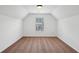 Attic bedroom with sloped ceilings and a window at 1955 Pius Dr, Ellenwood, GA 30294