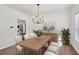 Elegant dining room with modern chandelier and a large wooden dining table with seating for six at 1955 Pius Dr, Ellenwood, GA 30294
