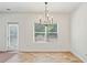View of an empty dining room with large window and linoleum flooring at 1955 Pius Dr, Ellenwood, GA 30294