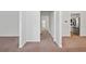 Hallway view with neutral carpet, white walls, and doorways leading to other rooms at 1955 Pius Dr, Ellenwood, GA 30294