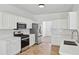 Well-lit kitchen with stainless steel appliances, white cabinets, and a white subway tile backsplash at 1955 Pius Dr, Ellenwood, GA 30294