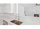 Modern kitchen with white quartz countertops, stainless appliances, and view into living room at 1955 Pius Dr, Ellenwood, GA 30294