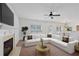 Spacious living room featuring a cozy fireplace, large sectional sofa, and bright windows at 1955 Pius Dr, Ellenwood, GA 30294