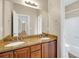 Bathroom with double vanity, granite countertop, framed mirror, and tile flooring at 231 Yardsley Dr, Mcdonough, GA 30253