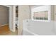 Bathroom with a soaking tub, white tile, and an attached closet at 231 Yardsley Dr, Mcdonough, GA 30253