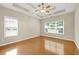 Spacious bedroom with tray ceiling, ceiling fan, and hardwood floors at 231 Yardsley Dr, Mcdonough, GA 30253